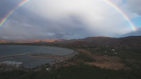a beautiful round rainbow fills the frame over the sea