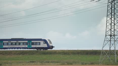 The-train-passes-through-the-green-farm-fields