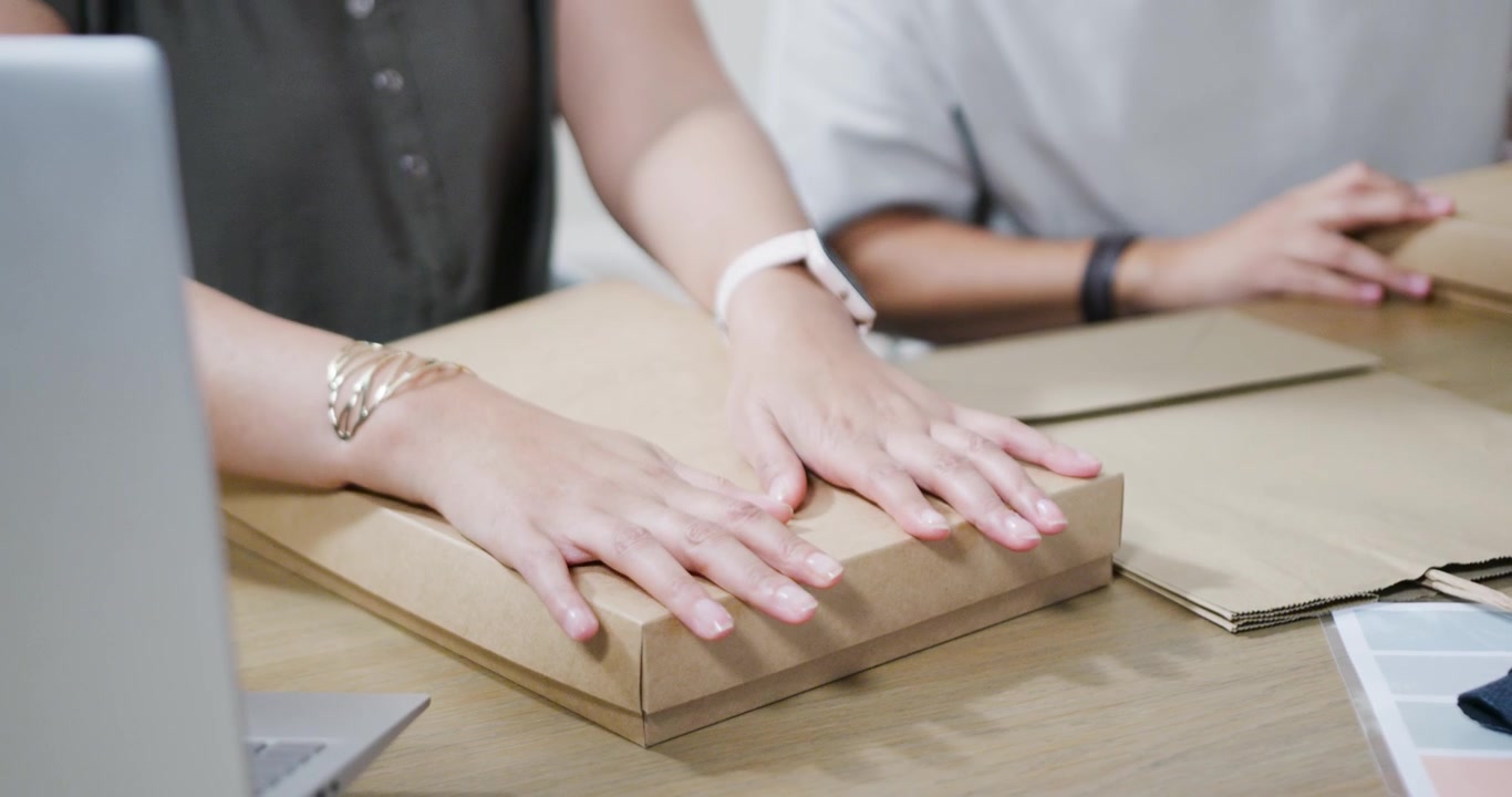 Small Business Owners Packing Orders in Cardboard Boxes