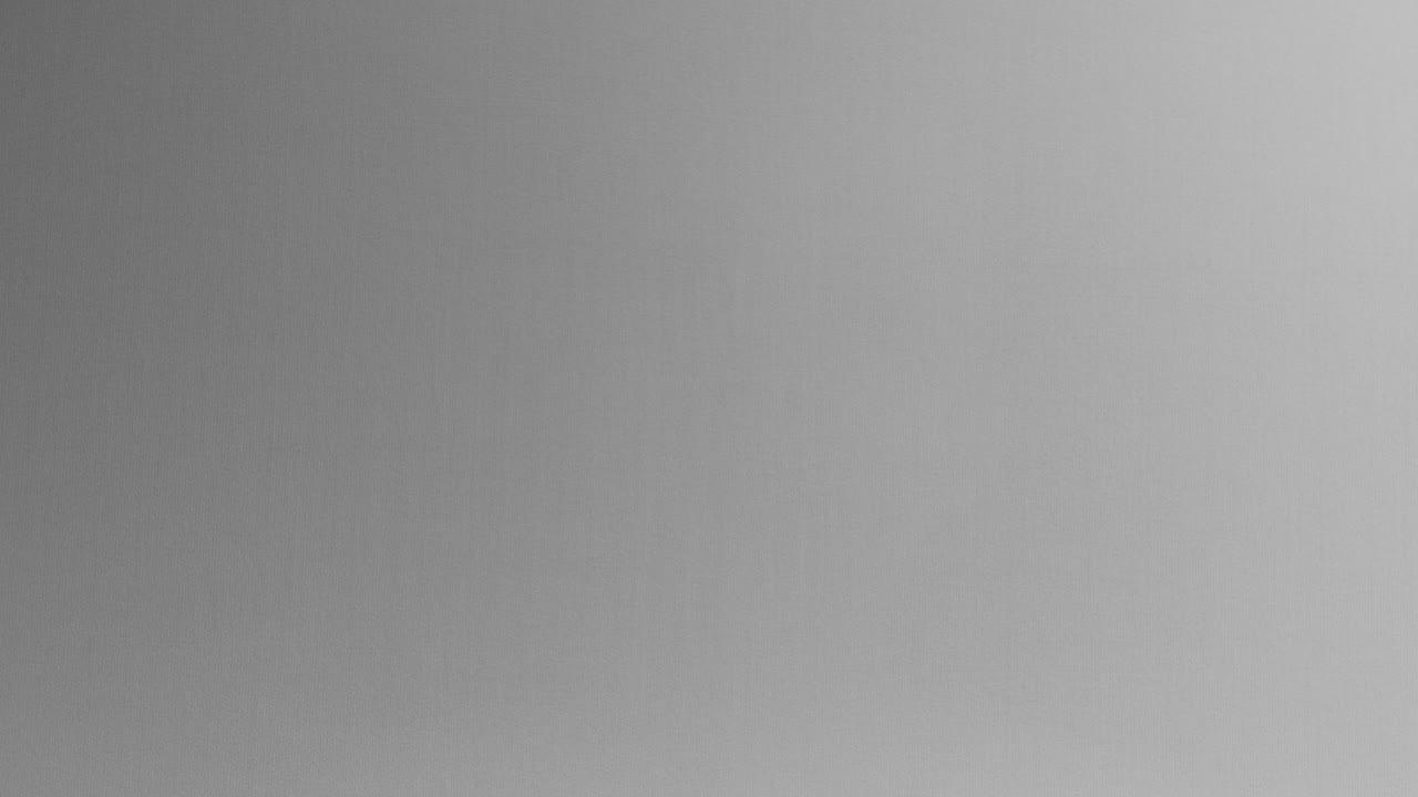 A creepy silhouette of a woman's face appears screaming from the white surface