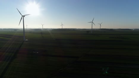 Aerial-pan-over-spinning-wind-turbines-on-a-wind-farm