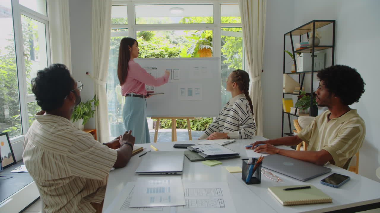 Multiethnic Team Applauding to Female Developer after Presentation