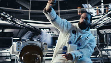 astronaut taking selfie pictures with smartphone, making hand gestures