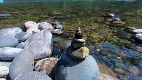 stone pyramid at river side from low angle at day