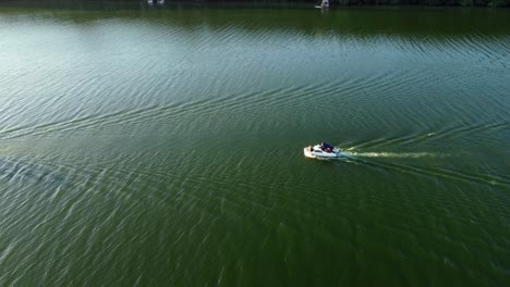 two sport boats driving on a small lake in brandenburg, germany