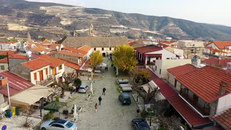 Coming-Into-Shot-Of-Omodos-Village-entrance,-Mountains-Landscape-In-Background,-Limassol-City,-Cyprus