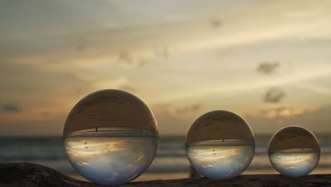 three crystal balls in golden sunset on a timber.