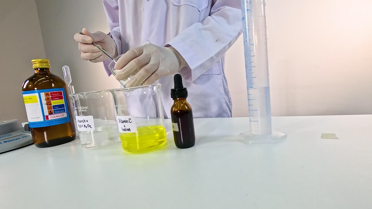 Scientist performs iodine clock reaction, mixing chemicals in a lab setting with controlled lighting and precise movements