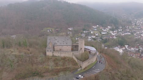 drone orbit shot from marburg castle, also known as the landgrave castle of marburg, is a medieval hilltop fortress overlooking the historic old town of marburg, germany