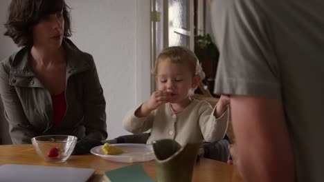 front view of family eating at home