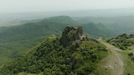 the medieval azeula fortress and a foggy, green wilderness in the background