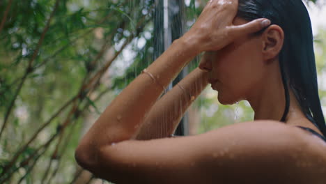 attractive-woman-in-shower-wearing-bikini-washing-body-cleansing-skin-with-refreshing-water-enjoying-natural-beauty-spa-showering-outdoors-in-nature
