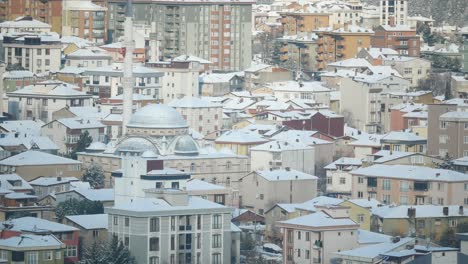 snowy cityscape with mosque
