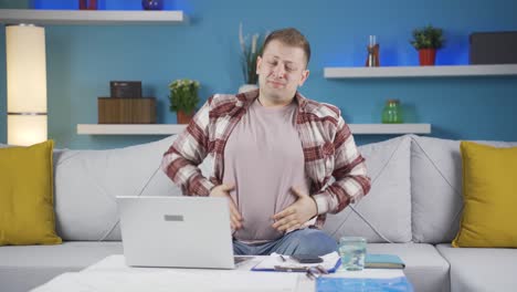 home office worker man has stomachache.