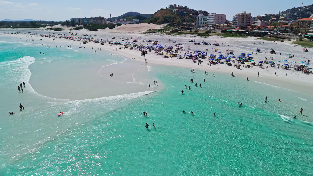 Drone view of Arraial do Cabo, crowded beach resort on east coast of Brazil - dolly forward