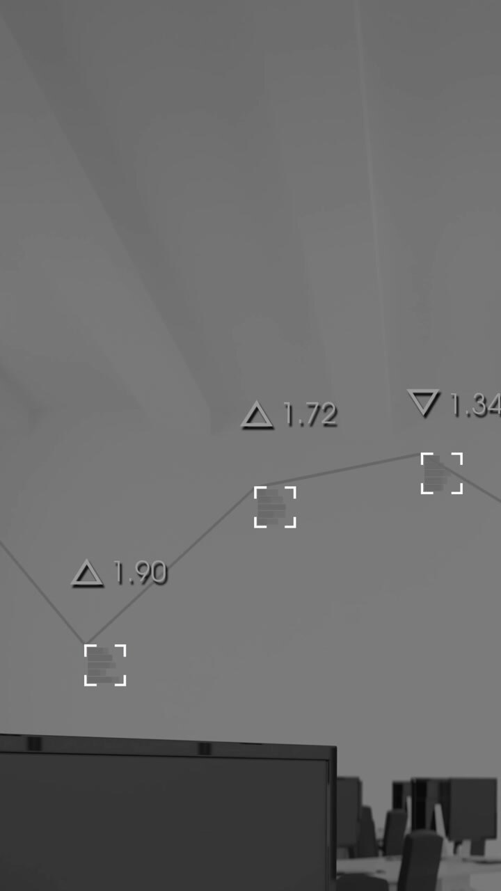 Animation of graph with viewfinders and changing numbers over desktops in office