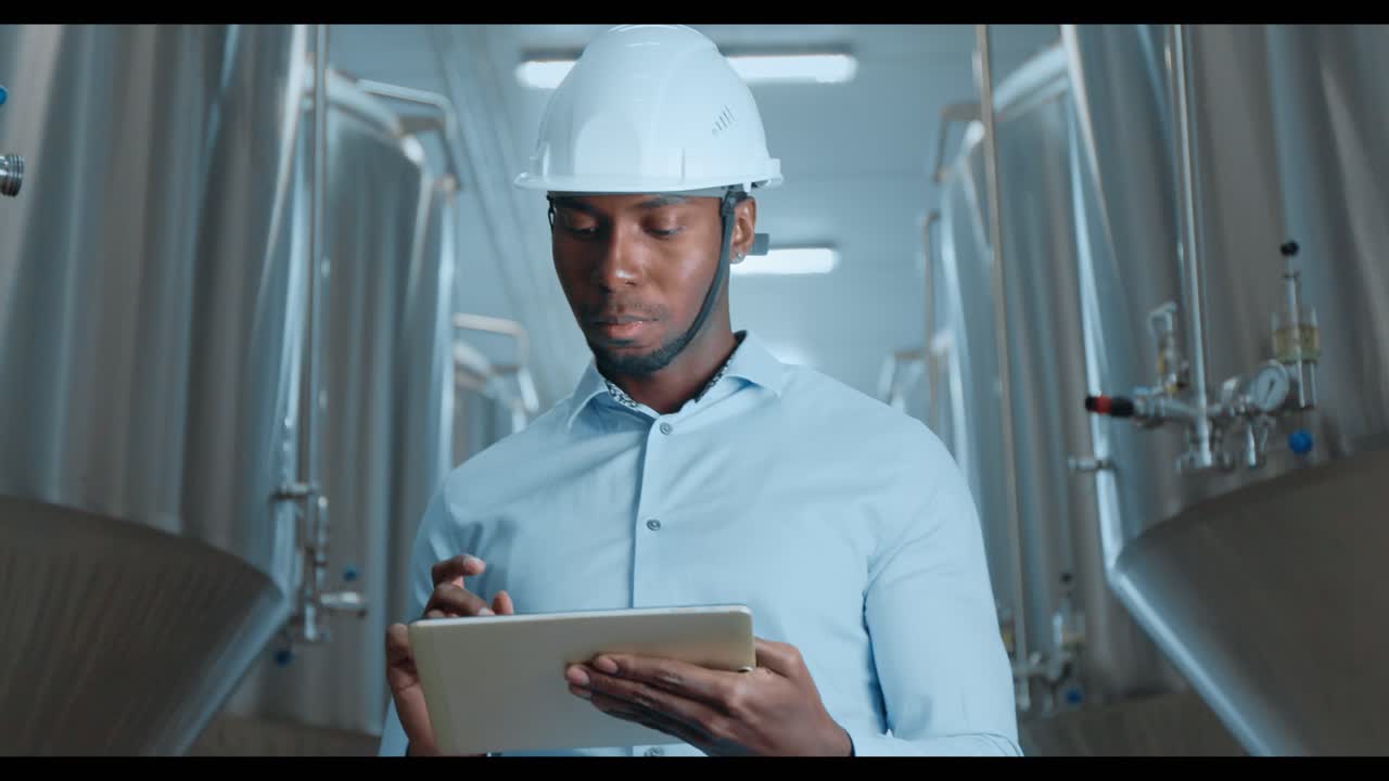 Engineer inspecting equipment at a brewery