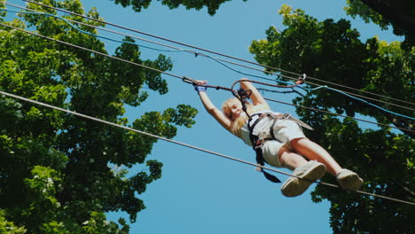 a brave child takes steps on a staggered cable at a height overcome fear concept