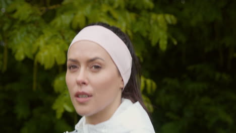 close up of woman wearing headband exercising keeping fit running in countryside or park 1