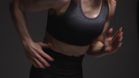 Close-Up-Studio-Shot-Of-Mature-Woman-Wearing-Gym-Fitness-Clothing-Doing-Cardio-Exercise-Running-On-The-Spot