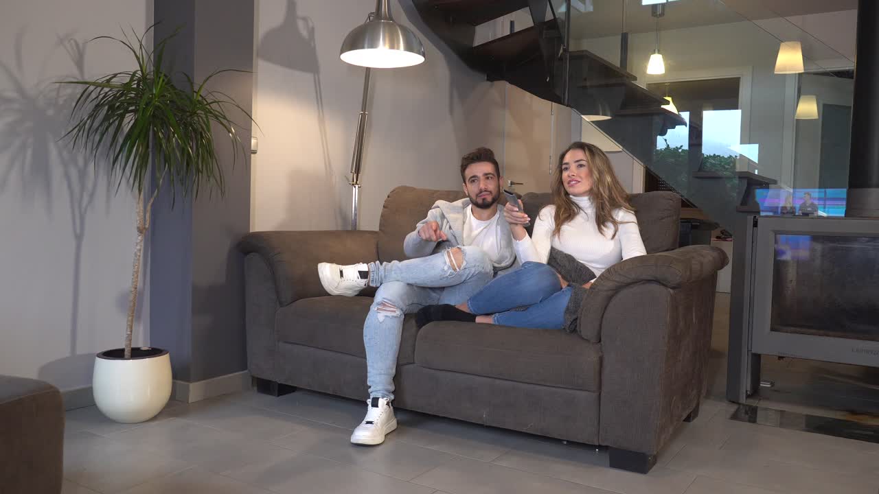 Couple Relaxing on Couch in Living Room