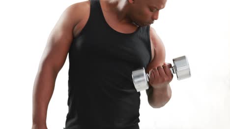 serious muscular man lifting dumbbells