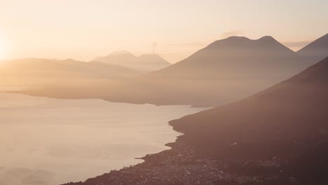 Morning-sun-rises-near-smoking-Fuego-volcano,-distance-time-lapse-view