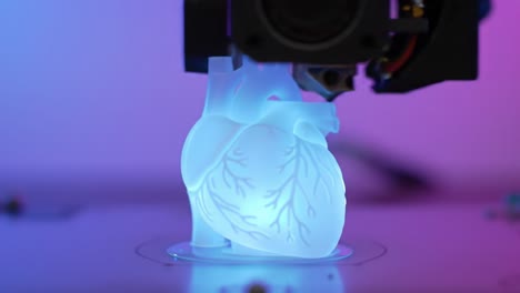 illuminated heart model in 3d printing process: captivating transformation from clear to vibrant glow in a dynamic printing environment