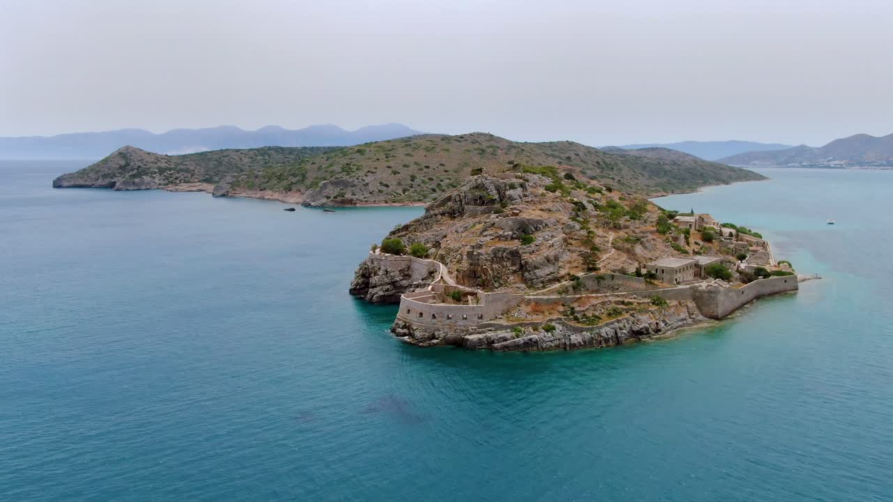 Aerial shot of the barren dry coastal landscape of Spinalonga island at Crete, Greece