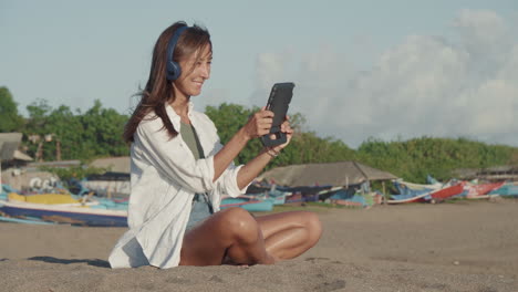 woman using tablet computer on beach