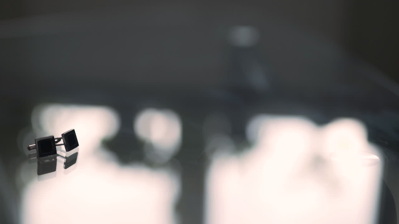 Close-up of Cufflinks on Glass Table