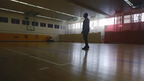 Male-Looking-At-Banners-high-On-Wall---Strong-Athletic-Muscular-Black-Man-Standing-On-Basketball-Court-Looking-Around-In-4K