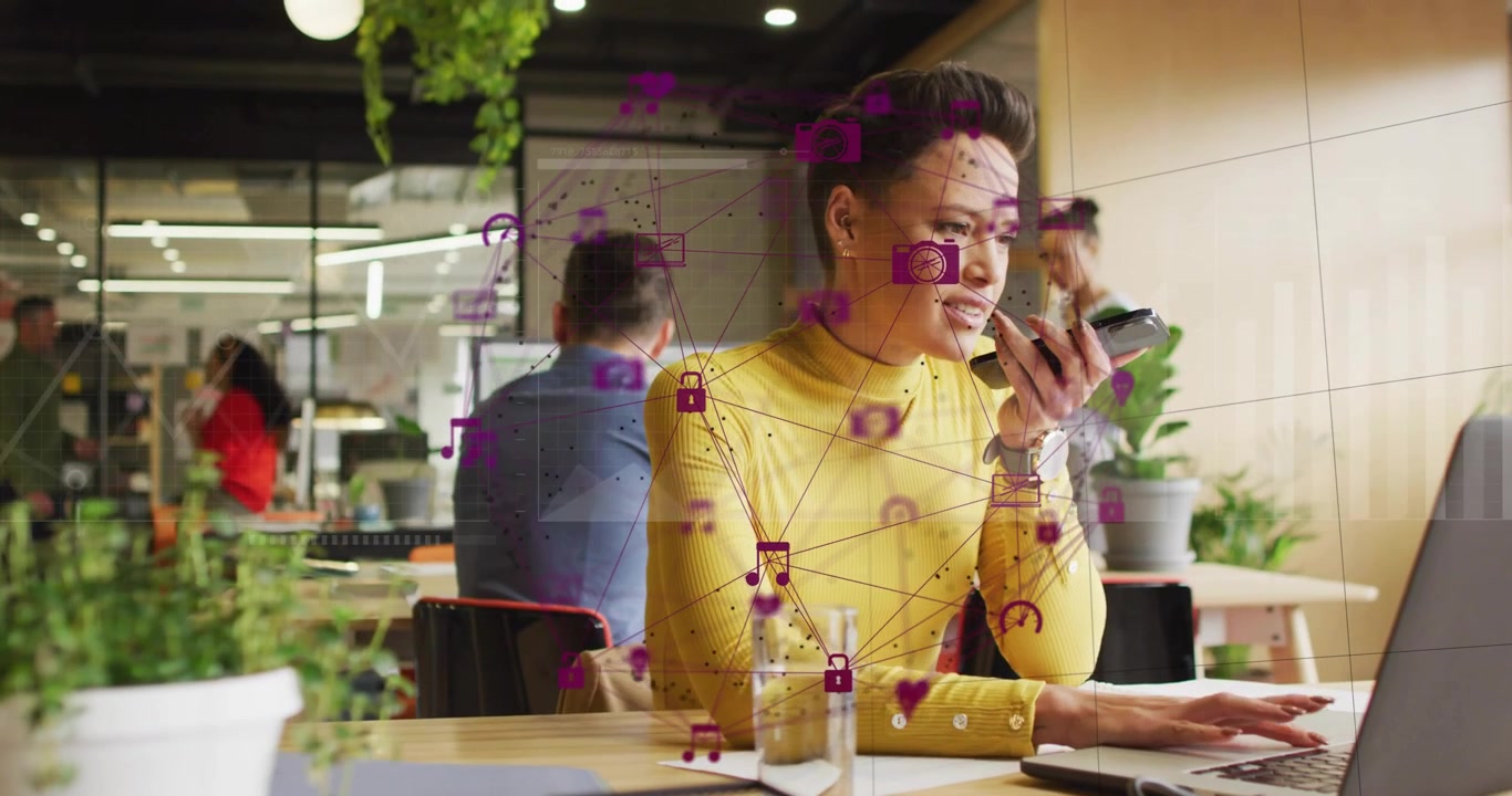 Mid adult woman speaking voice-command and typing as purple network icons animating office data