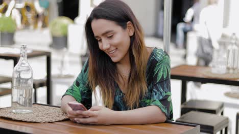 mujer joven leyendo un mensaje en su teléfono