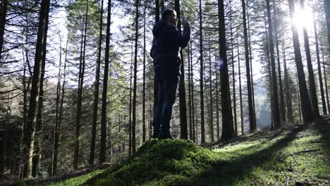 man talking on the phone in a forest