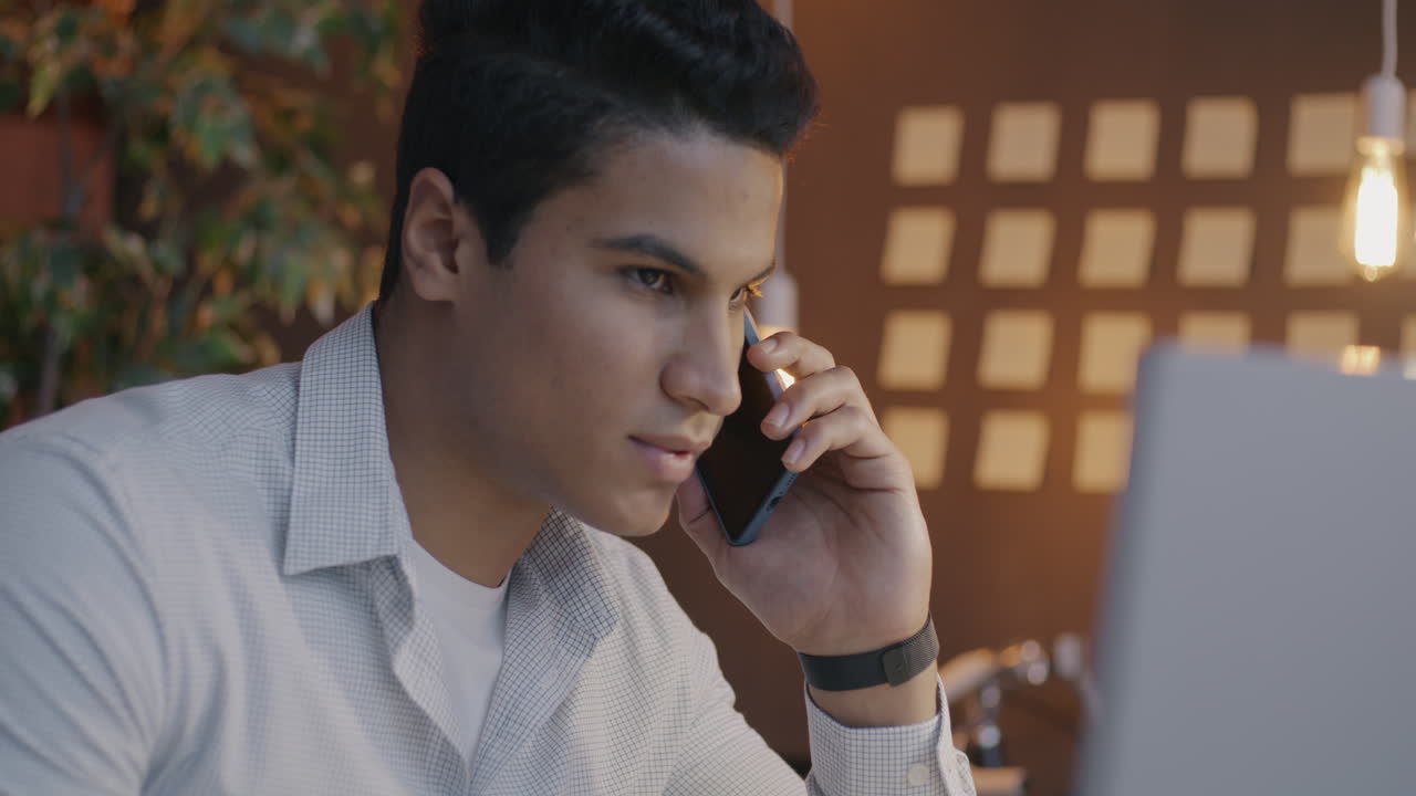 Young Man on a Phone Call in an Office