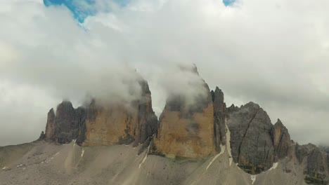 clouds moving over three peaks unesco mountain range dolomites, italy