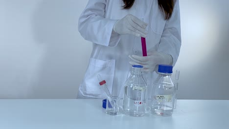 scientist demonstrates color change with phenolphthalein