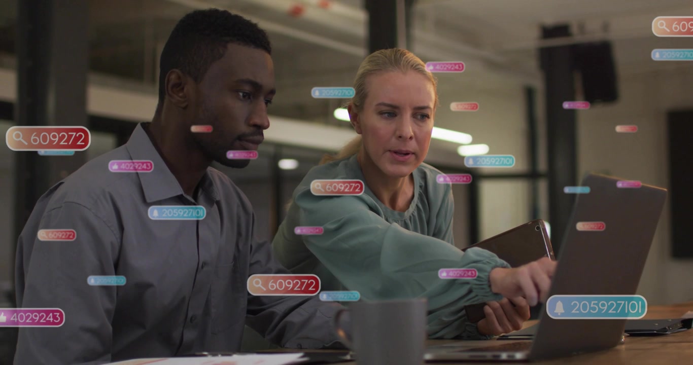 Woman tapping laptop trackpad and using tablet, guiding man through business data with UI overlays