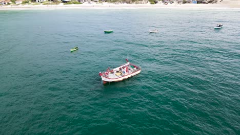 Escena-Aérea-De-Drones-De-Un-Barco-De-Pesca-A-La-Deriva-Sin-Gente-Cerca-De-La-Playa-Mar-En-Calma-Con-Otros-Barcos-Cerca-De-Ingles-Beach-Florianópolis