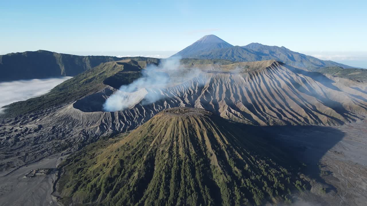 Stunning aerial perspective of active Mount Bromo with dramatic textures, crater smoke, and surrounding Tengger mountains