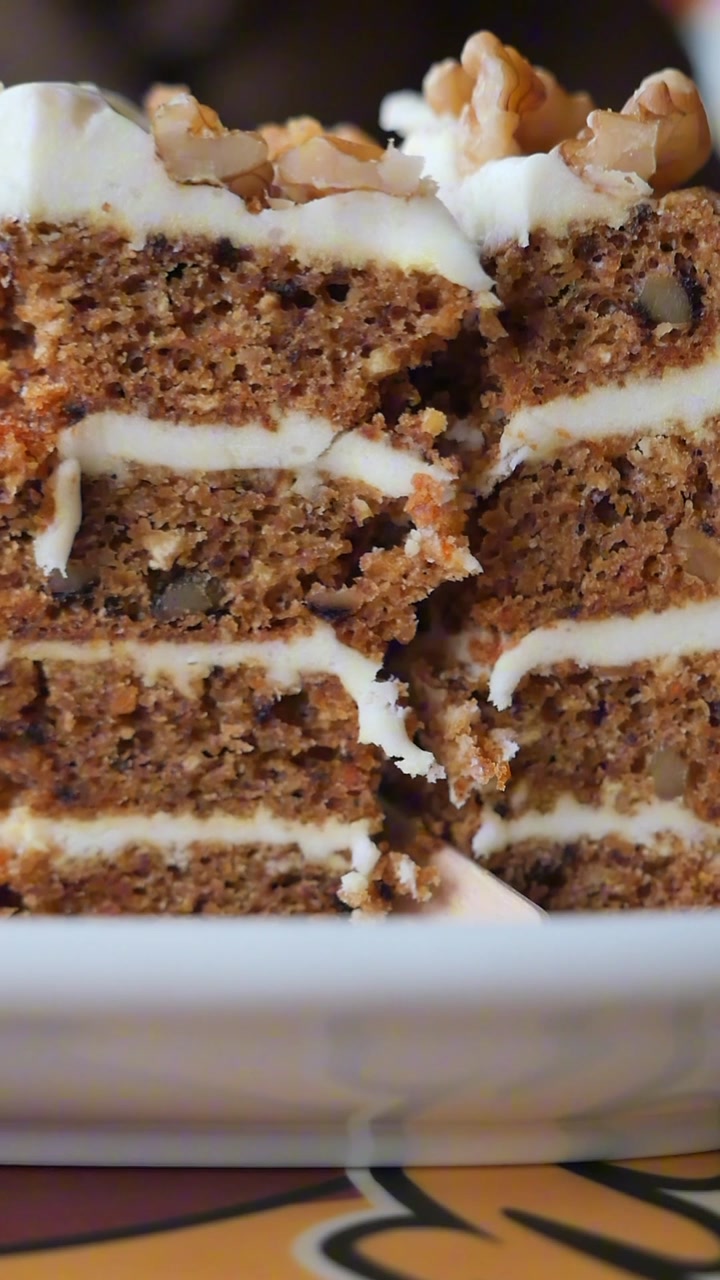 Fork Taking a Bite from a Delicious Carrot Cake Slice