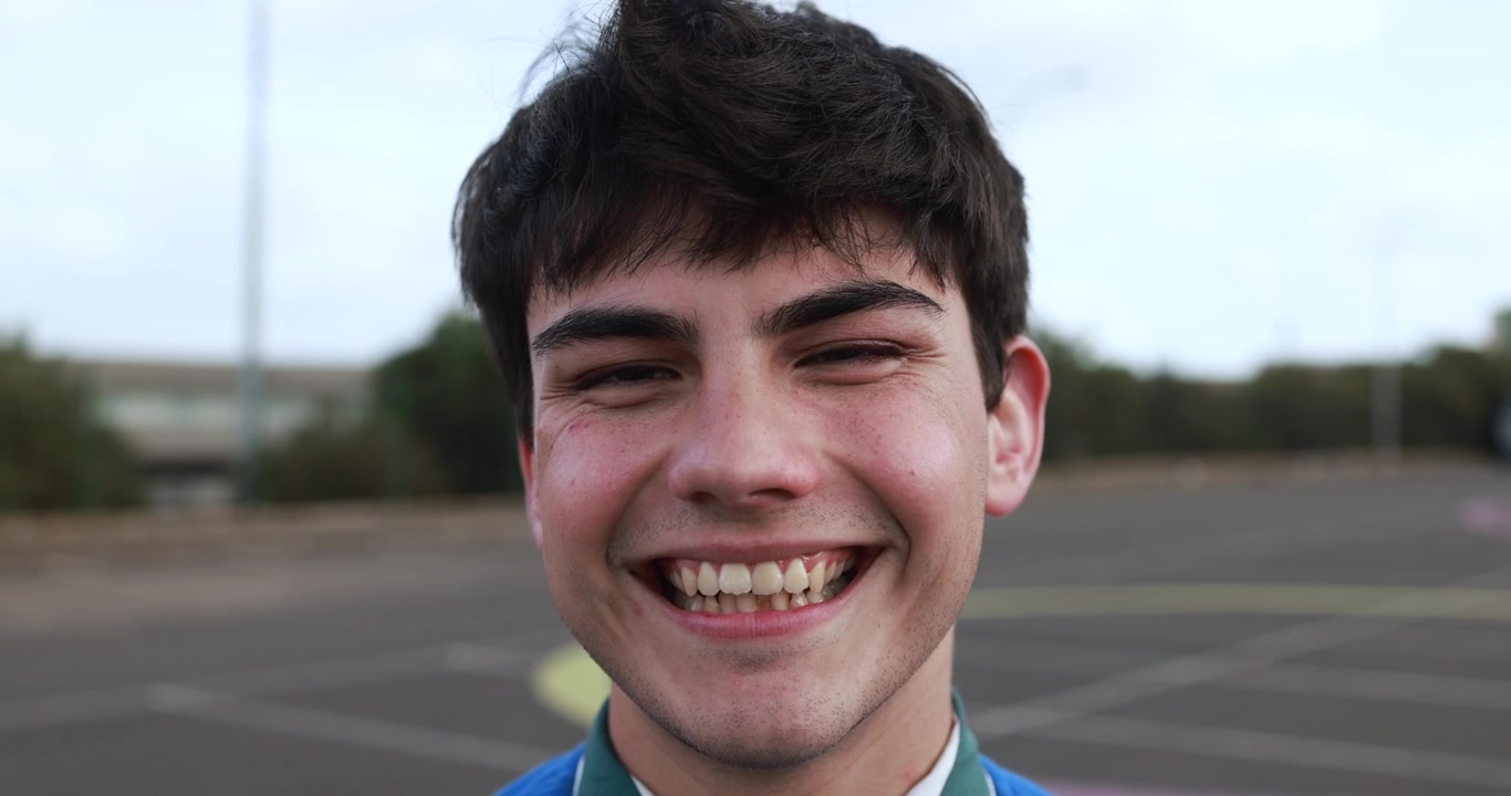 Close-up Portrait of a Happy Young Man Smiling at the Camera