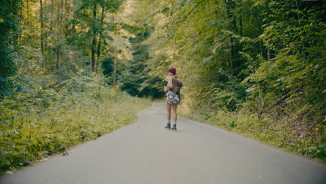 Tourist-Walking-On-Footpath-amidst-Trees-In-Forest