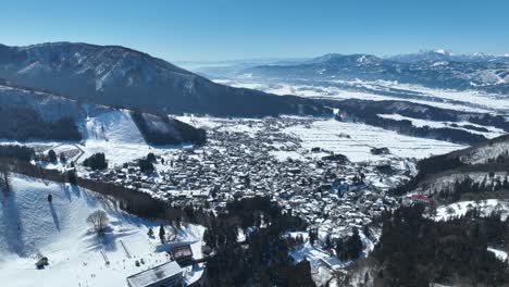 aerial establishing shot of japans nozawaonsen mountain ski resort village