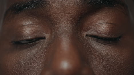 extreme closeup surprised african american male eyes looking at camera.