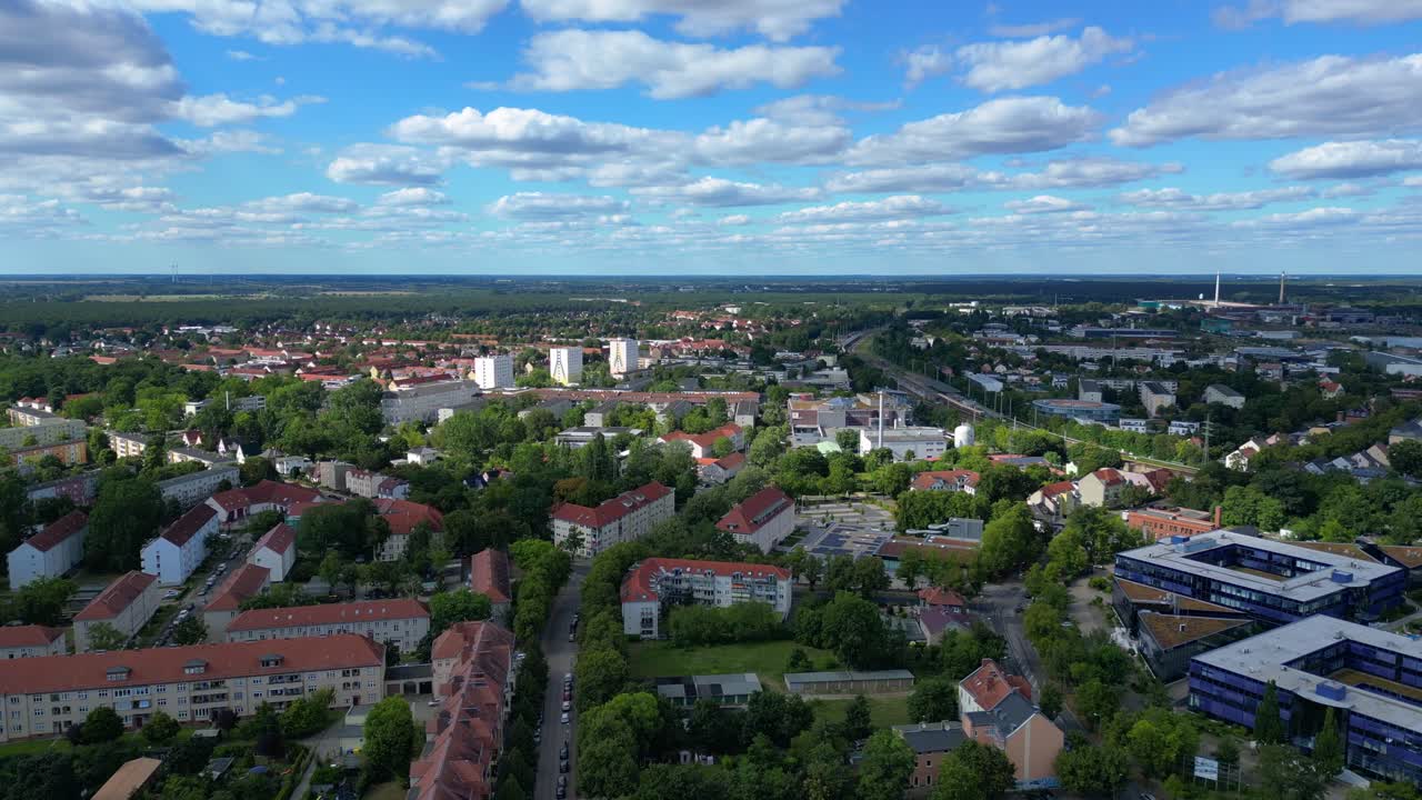 Hennigsdorf, Germany, showcasing residential areas, railway infrastructure and commercial buildings. Nice aerial view flight panorama overview drone