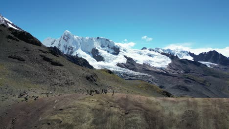 group of hikers in the peruvian andes near ausangate, captured from above. stunning views of snow, open skies, and untouched nature in this remote trekking region