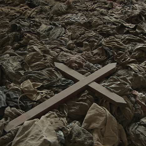 a cross sits amongst the scattered clothing of victims following a genocide in a church in rwanda