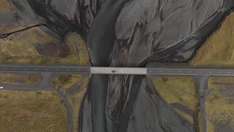 Aerial-shot-of-a-bridge-crossing-a-glacial-river-system